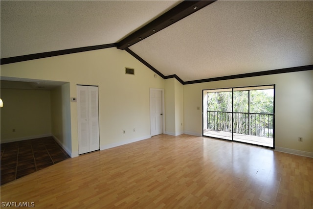 unfurnished living room featuring beamed ceiling, high vaulted ceiling, hardwood / wood-style flooring, and a textured ceiling