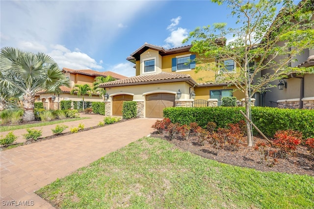 mediterranean / spanish house featuring a front lawn and a garage