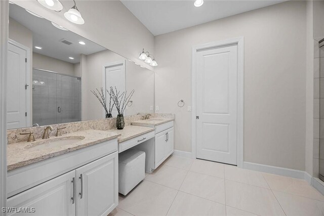 bathroom with vanity, an enclosed shower, and tile patterned flooring