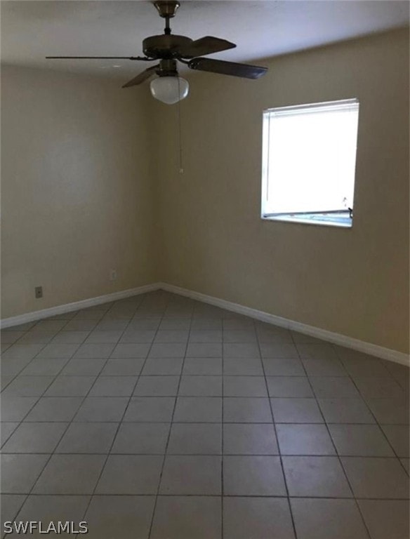 spare room with light tile flooring and ceiling fan