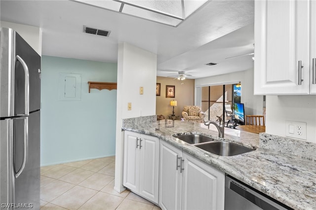 kitchen featuring appliances with stainless steel finishes, ceiling fan, white cabinets, and sink