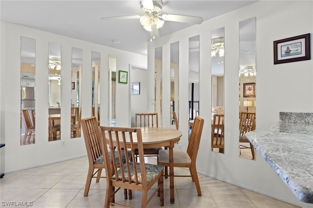 tiled dining area featuring ceiling fan