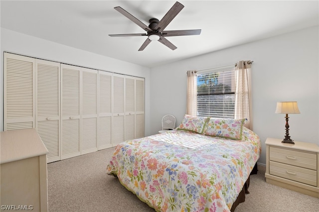 carpeted bedroom featuring ceiling fan and a closet