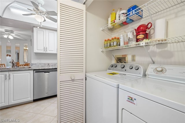 laundry area featuring independent washer and dryer, ceiling fan, light tile patterned flooring, and sink