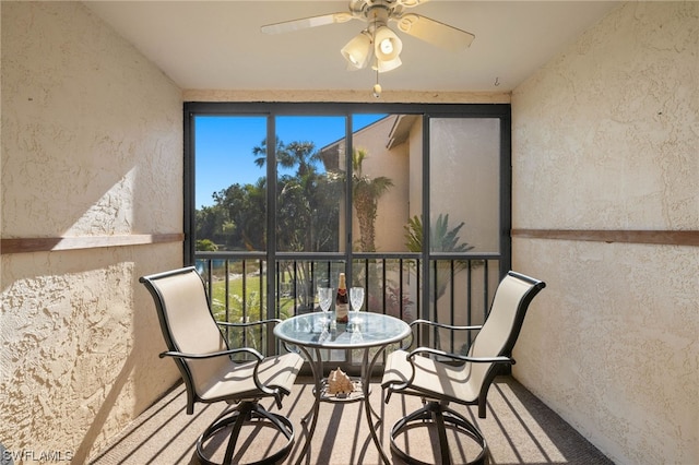 sunroom featuring ceiling fan