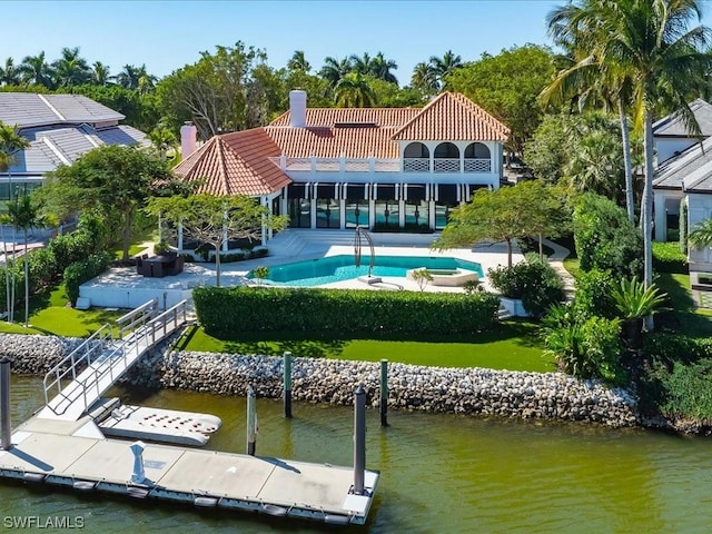 rear view of property with a water view and a patio