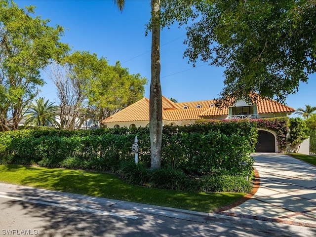 mediterranean / spanish-style home with a garage