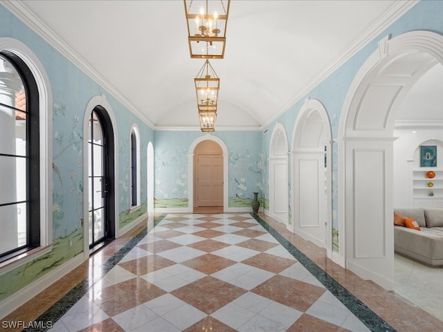 corridor with a notable chandelier, lofted ceiling, and crown molding