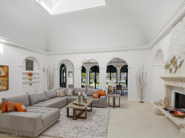 living room with built in shelves, crown molding, a high end fireplace, and light tile patterned floors