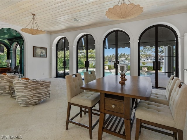 dining space with french doors, plenty of natural light, and wood ceiling