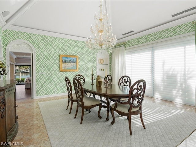 dining area with crown molding and an inviting chandelier