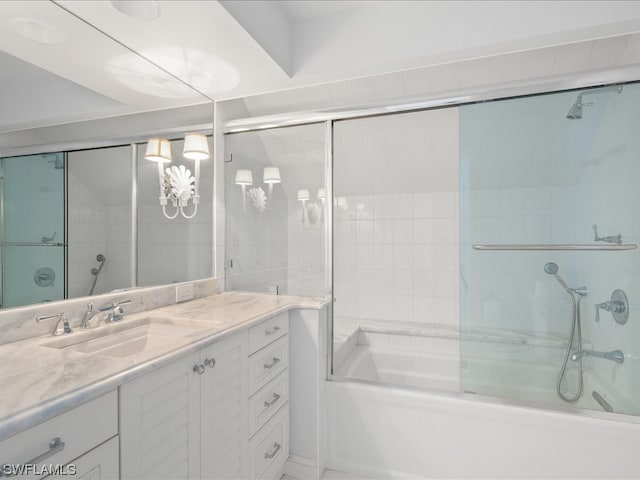 bathroom with vanity and combined bath / shower with glass door