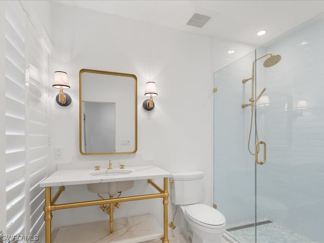 bathroom featuring sink, toilet, and walk in shower