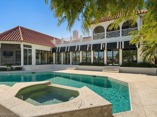 view of pool with an in ground hot tub and a patio area