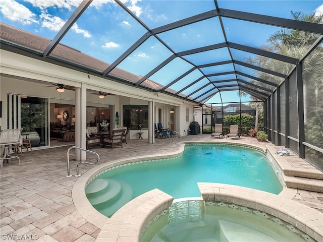 view of swimming pool featuring a lanai, ceiling fan, and a patio area