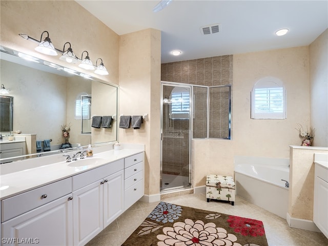 bathroom featuring vanity, tile floors, and separate shower and tub