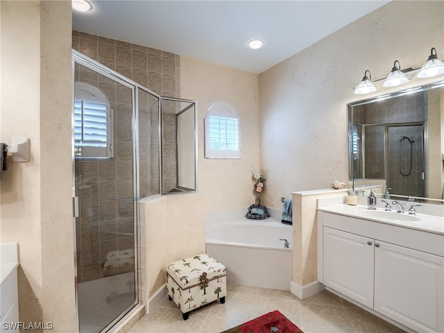 bathroom featuring tile floors, independent shower and bath, and vanity