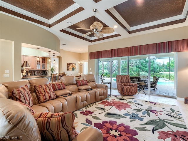 living room featuring a wealth of natural light, coffered ceiling, light tile floors, and ceiling fan with notable chandelier