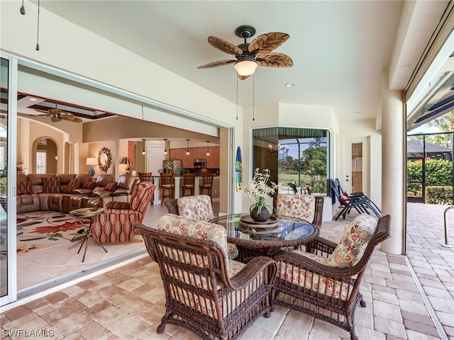 view of terrace with outdoor lounge area and ceiling fan