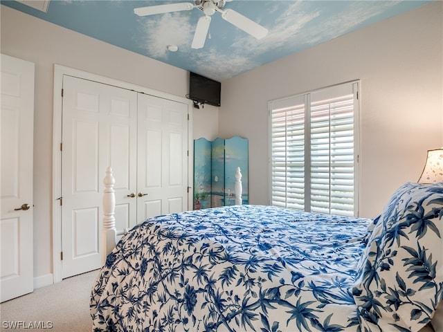 carpeted bedroom with a closet and ceiling fan