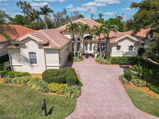 mediterranean / spanish-style home featuring a garage