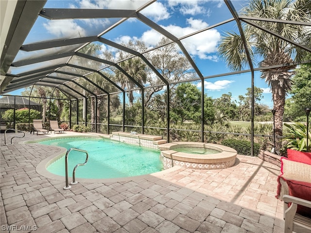 view of swimming pool featuring a lanai, a patio area, and an in ground hot tub