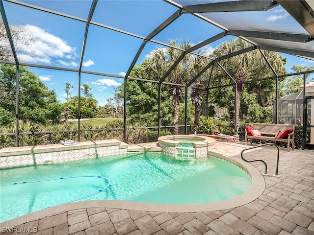 view of swimming pool featuring an in ground hot tub, a lanai, and a patio area