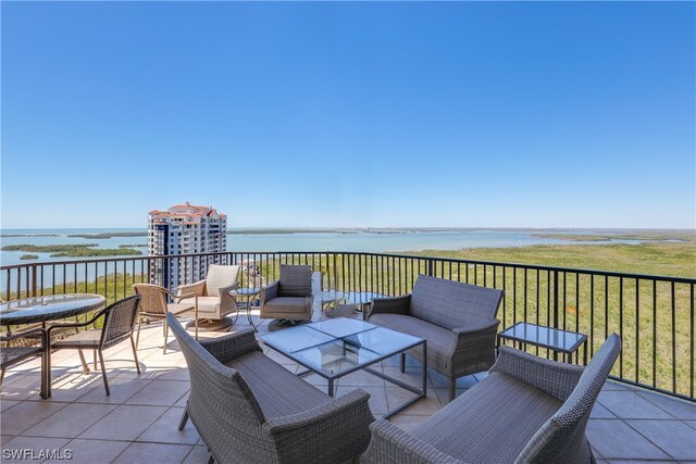 view of terrace featuring a balcony, an outdoor hangout area, and a water view