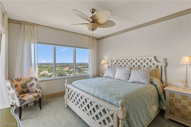 carpeted bedroom with crown molding and ceiling fan