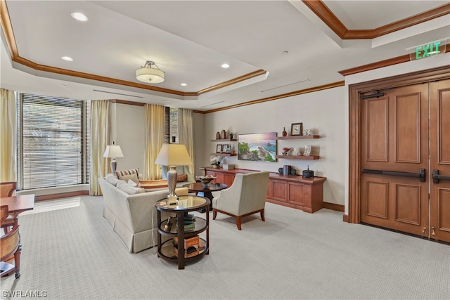 living room with light carpet, ornamental molding, and a tray ceiling