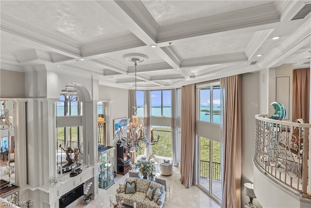 sunroom featuring a notable chandelier, beam ceiling, and coffered ceiling