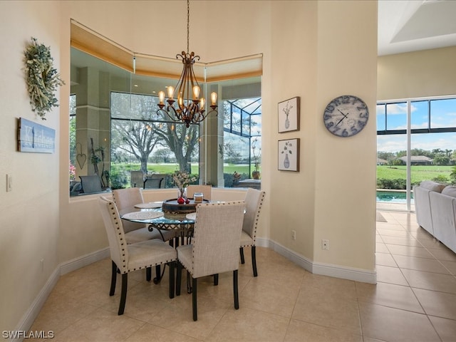 dining room with a healthy amount of sunlight, an inviting chandelier, and light tile patterned flooring