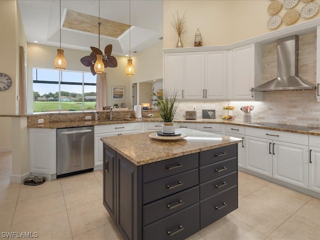 kitchen featuring white cabinetry, light tile patterned floors, a kitchen island, wall chimney exhaust hood, and stainless steel dishwasher