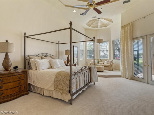 carpeted bedroom with access to outside, a high ceiling, and ceiling fan