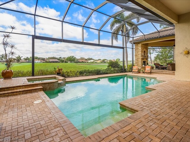 view of swimming pool featuring a lanai, a patio area, and an in ground hot tub