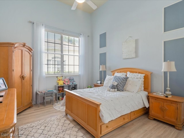 bedroom with ceiling fan and light wood-type flooring