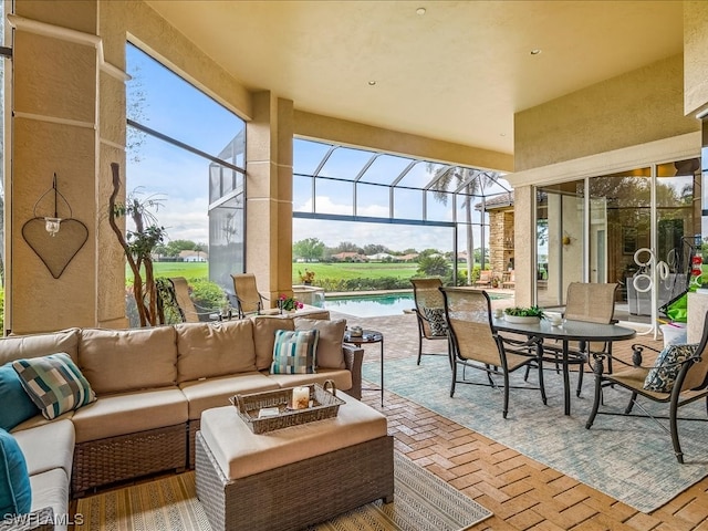 sunroom / solarium featuring a water view