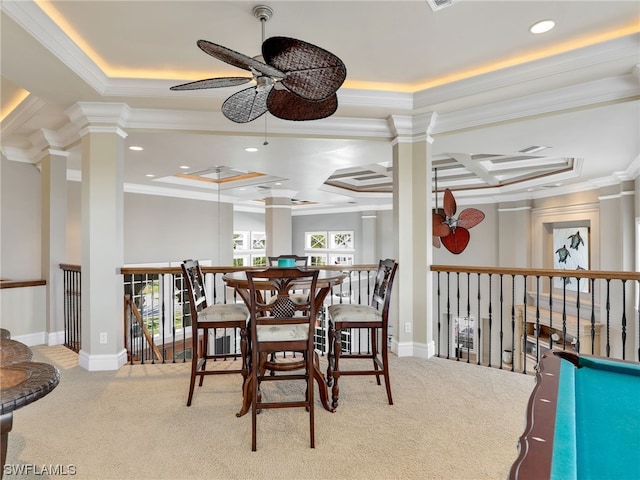 carpeted dining space featuring coffered ceiling, ornamental molding, ceiling fan, and a raised ceiling