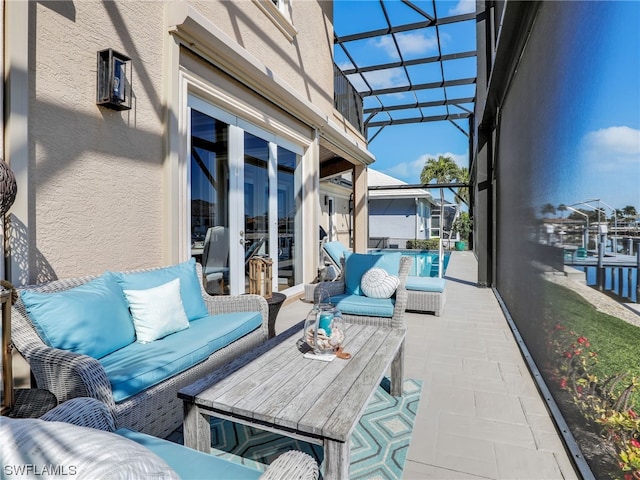 view of patio with an outdoor living space and a lanai