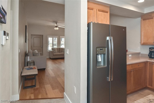 kitchen featuring light hardwood / wood-style flooring, stainless steel fridge with ice dispenser, and ceiling fan