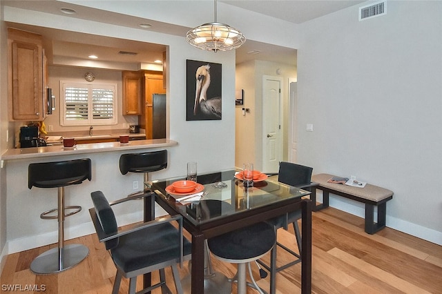 dining space with light wood-type flooring