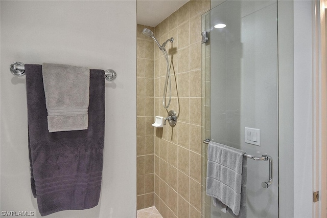 bathroom with a shower with shower door