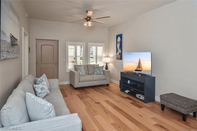 living room featuring ceiling fan and light wood-type flooring