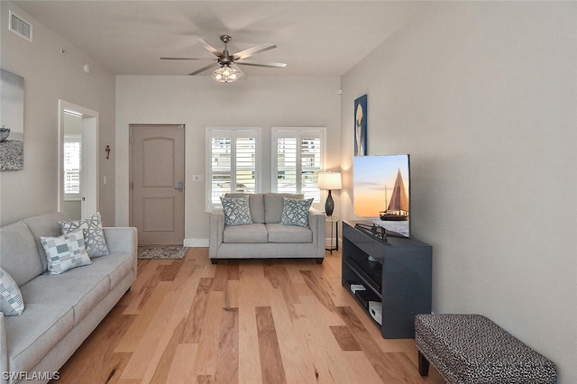 living room with ceiling fan and hardwood / wood-style floors