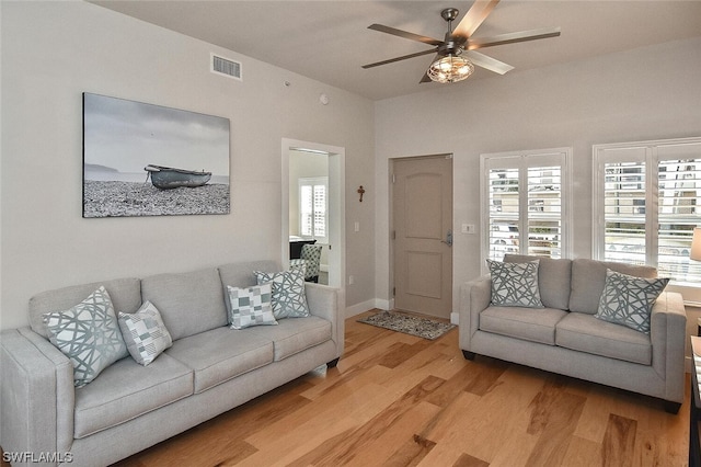 living room featuring ceiling fan and light hardwood / wood-style flooring