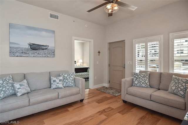 living room with ceiling fan and light hardwood / wood-style flooring