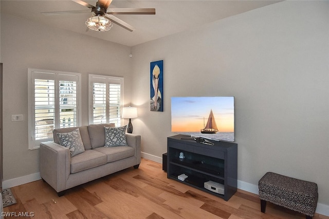 living room with ceiling fan and light hardwood / wood-style floors