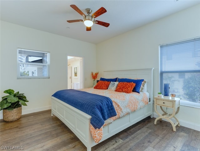 bedroom featuring dark hardwood / wood-style flooring and ceiling fan