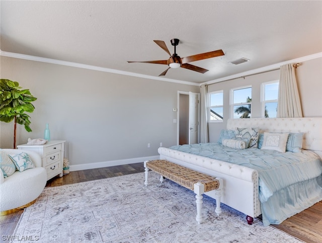 bedroom with ceiling fan, hardwood / wood-style flooring, and ornamental molding