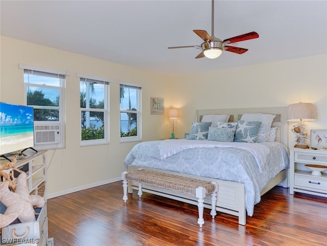 bedroom with multiple windows, ceiling fan, and dark hardwood / wood-style floors